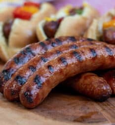 Grilled Italian Sausages with buns and toppings.