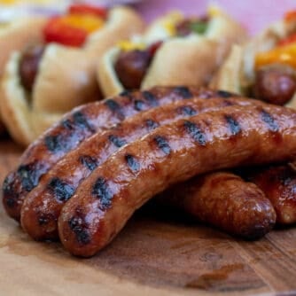 Grilled Italian Sausages with buns and toppings.