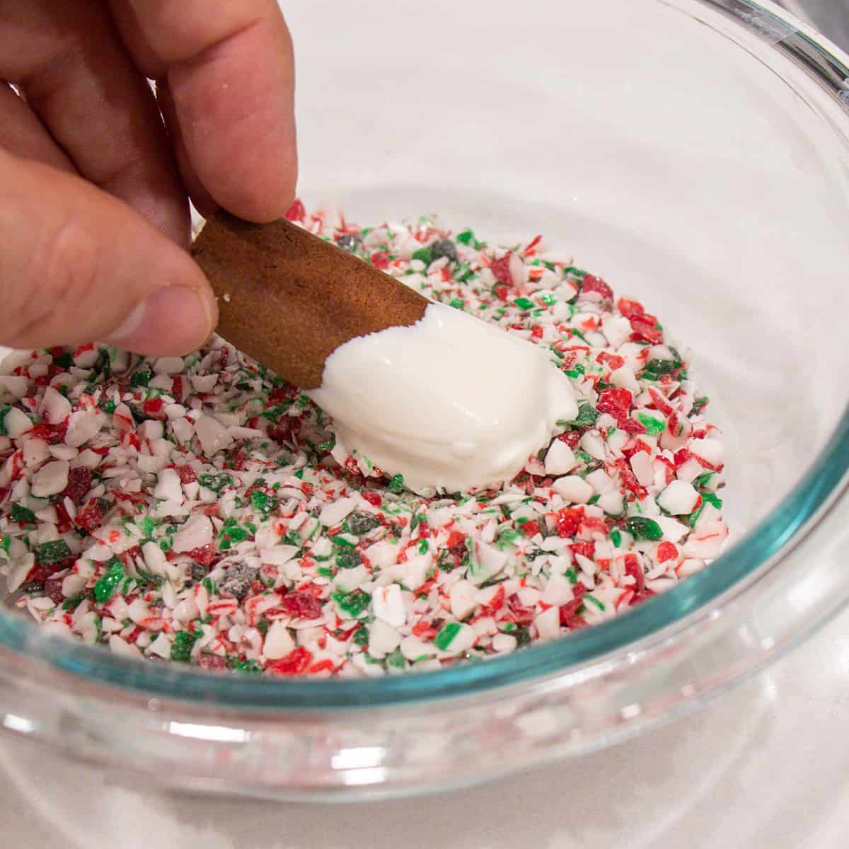 Dredging the cookie in a bowl of crushed candy canes.