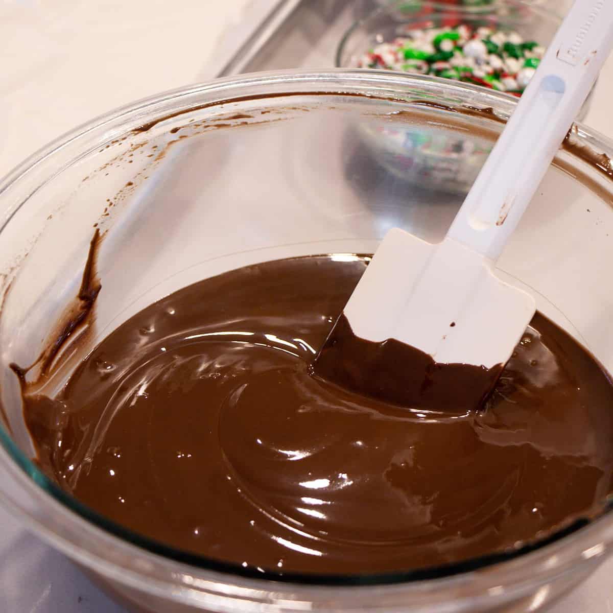 Melted dark chocolate ready to be spread on the baking sheet.