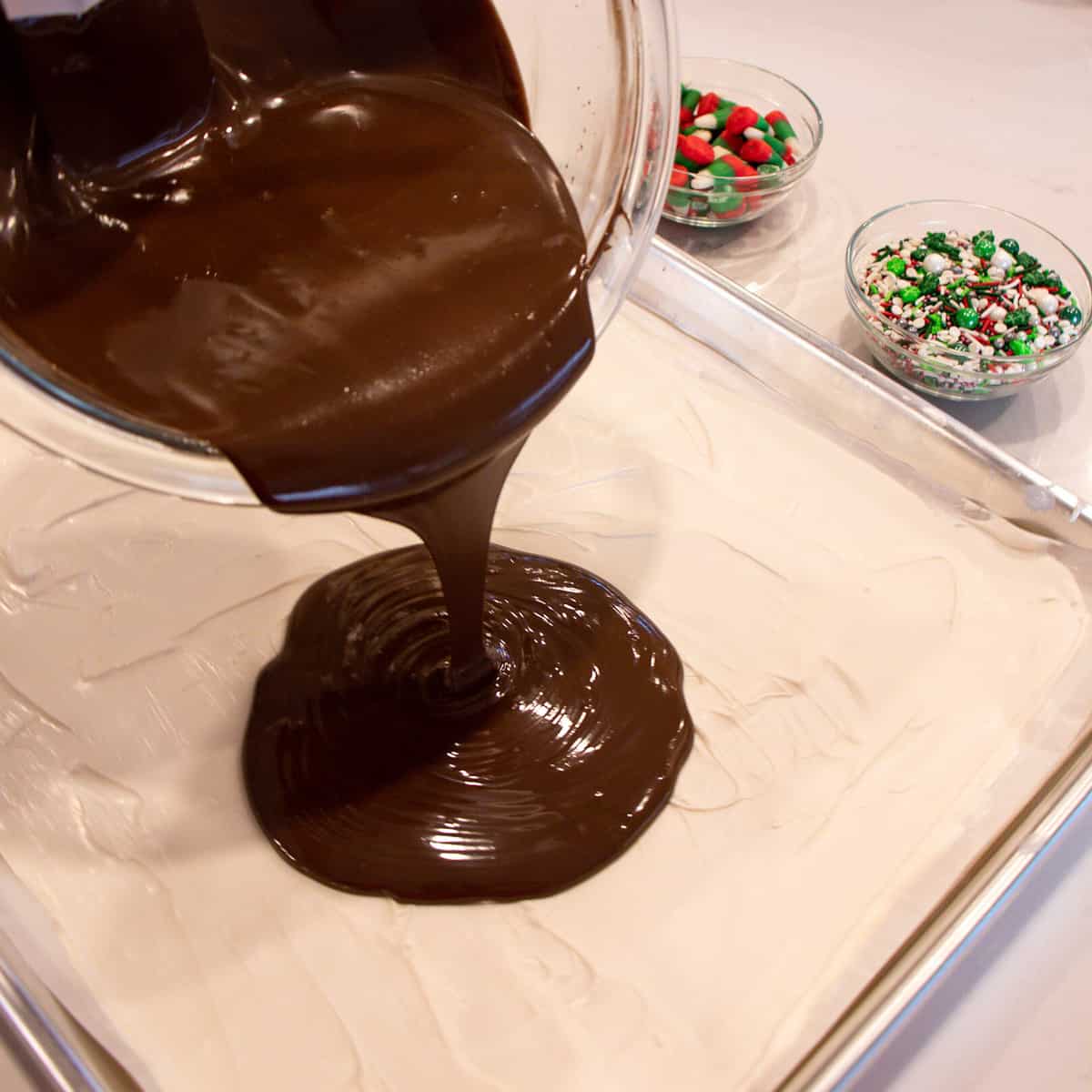 Melted dark chocolate being poured over the white chocolate.