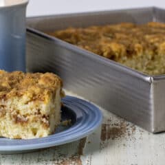 A small plate with a slice of fresh baked cake.