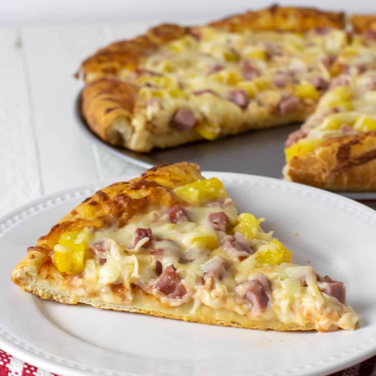 A slice of Hawaiian pizza. 