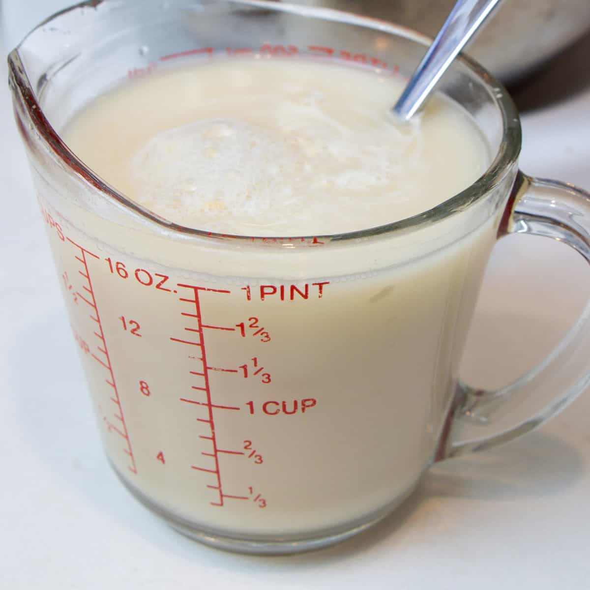 Dissolved yeast in a measuring cup with warm water.