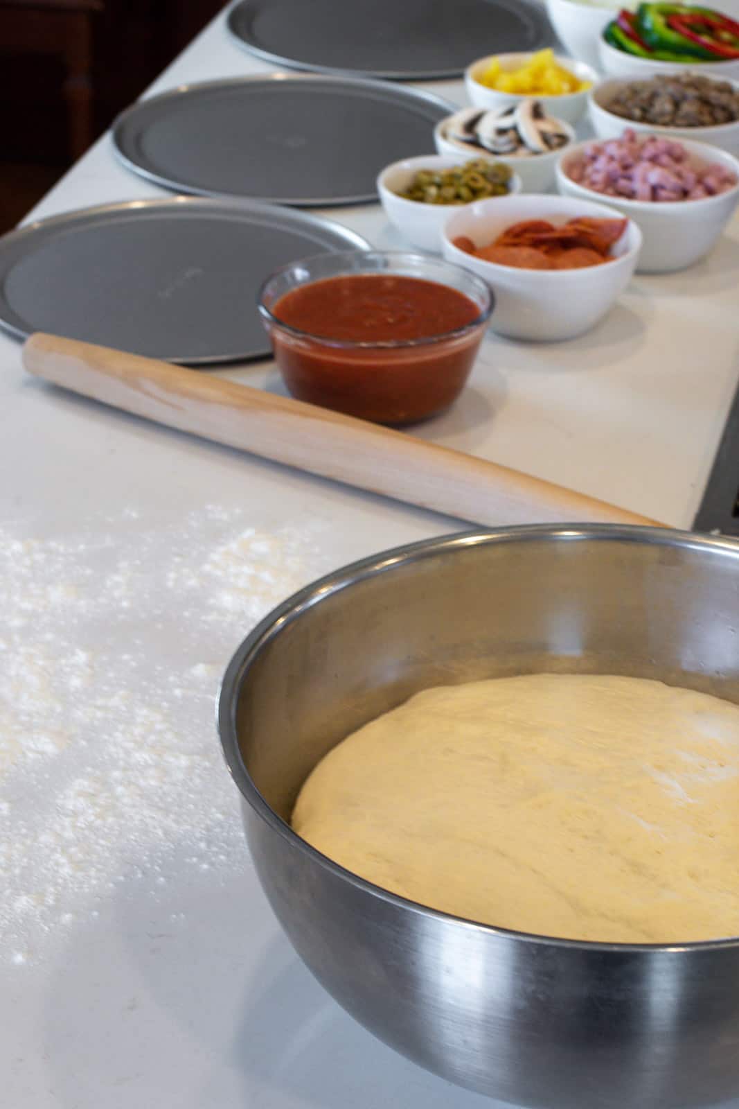 An overhead picture of ingredients to make a homemade pizza.