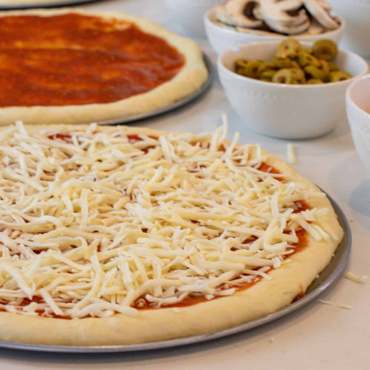 Sauce and cheese on a pizza crust.