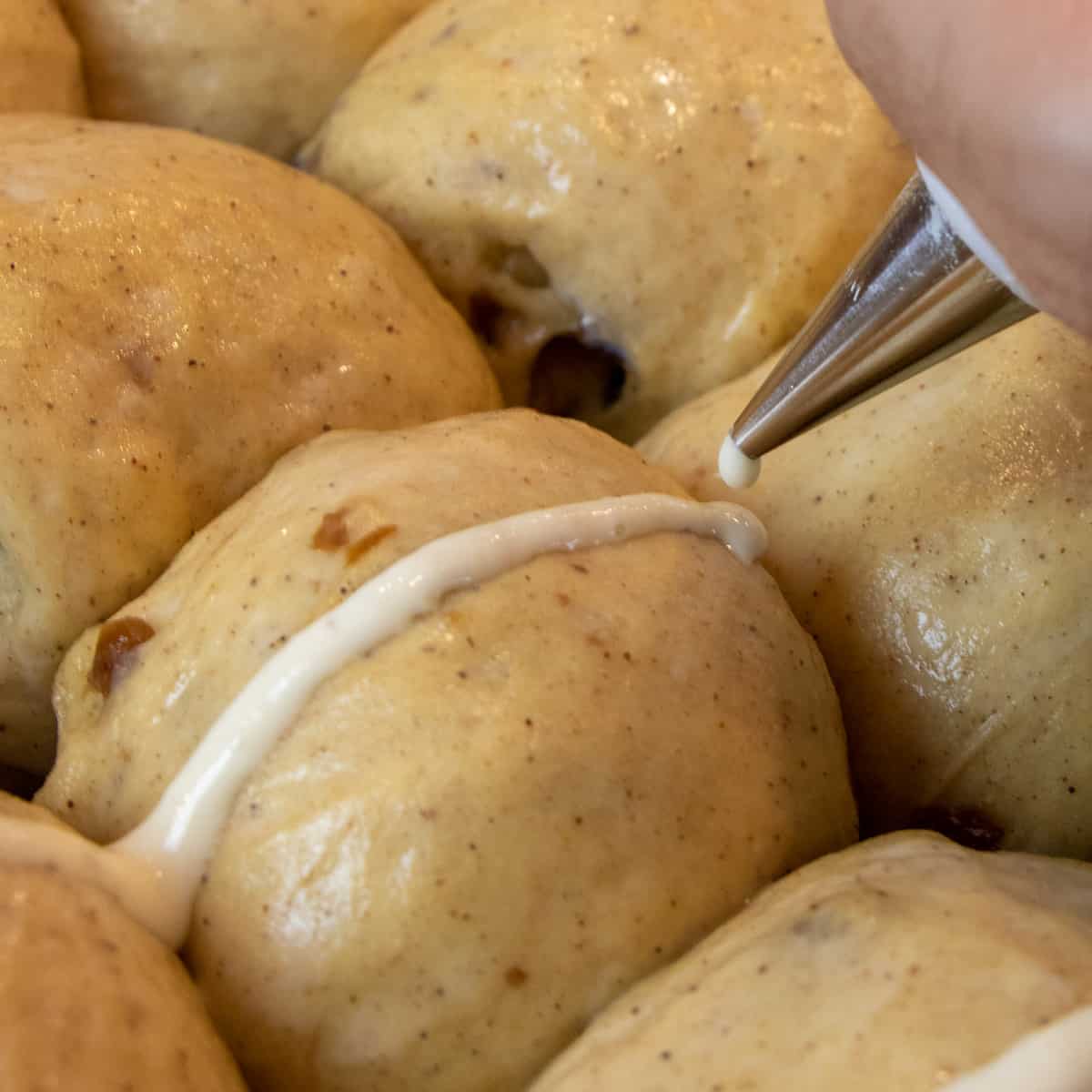 Piping the cross with flour and water paste.