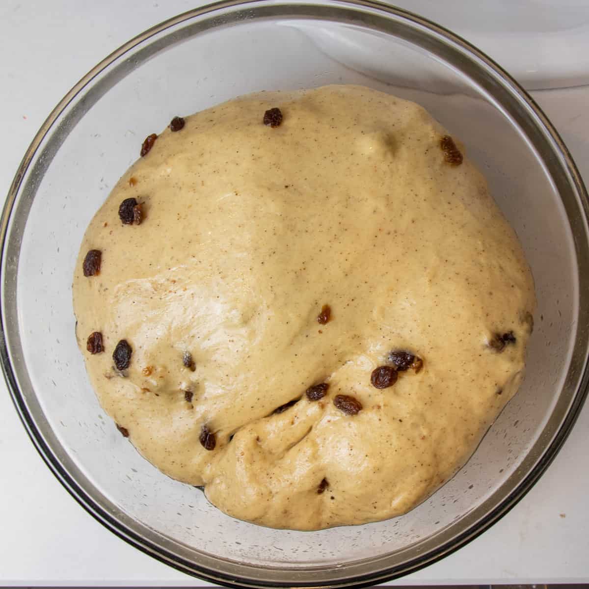 Risen dough in a glass bowl.