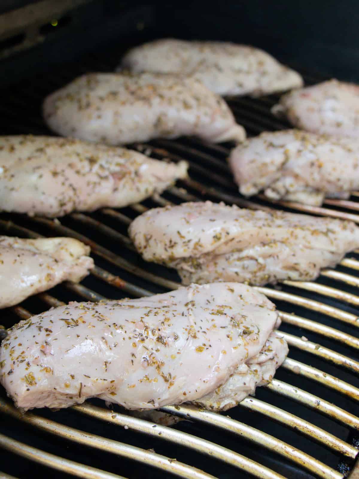 Raw chicken on a hot grill.