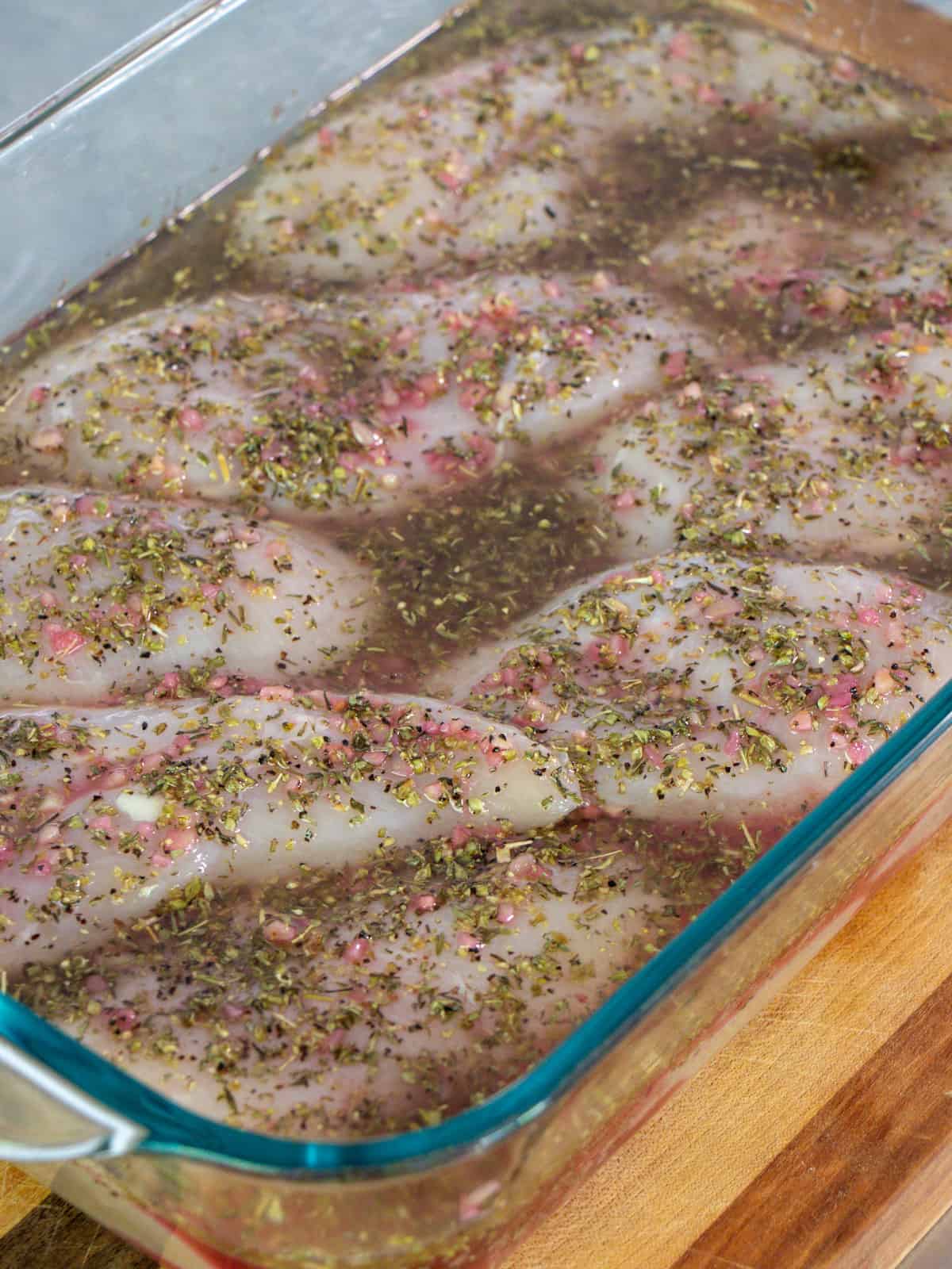 Marinade poured over boneless skinless chicken breasts.