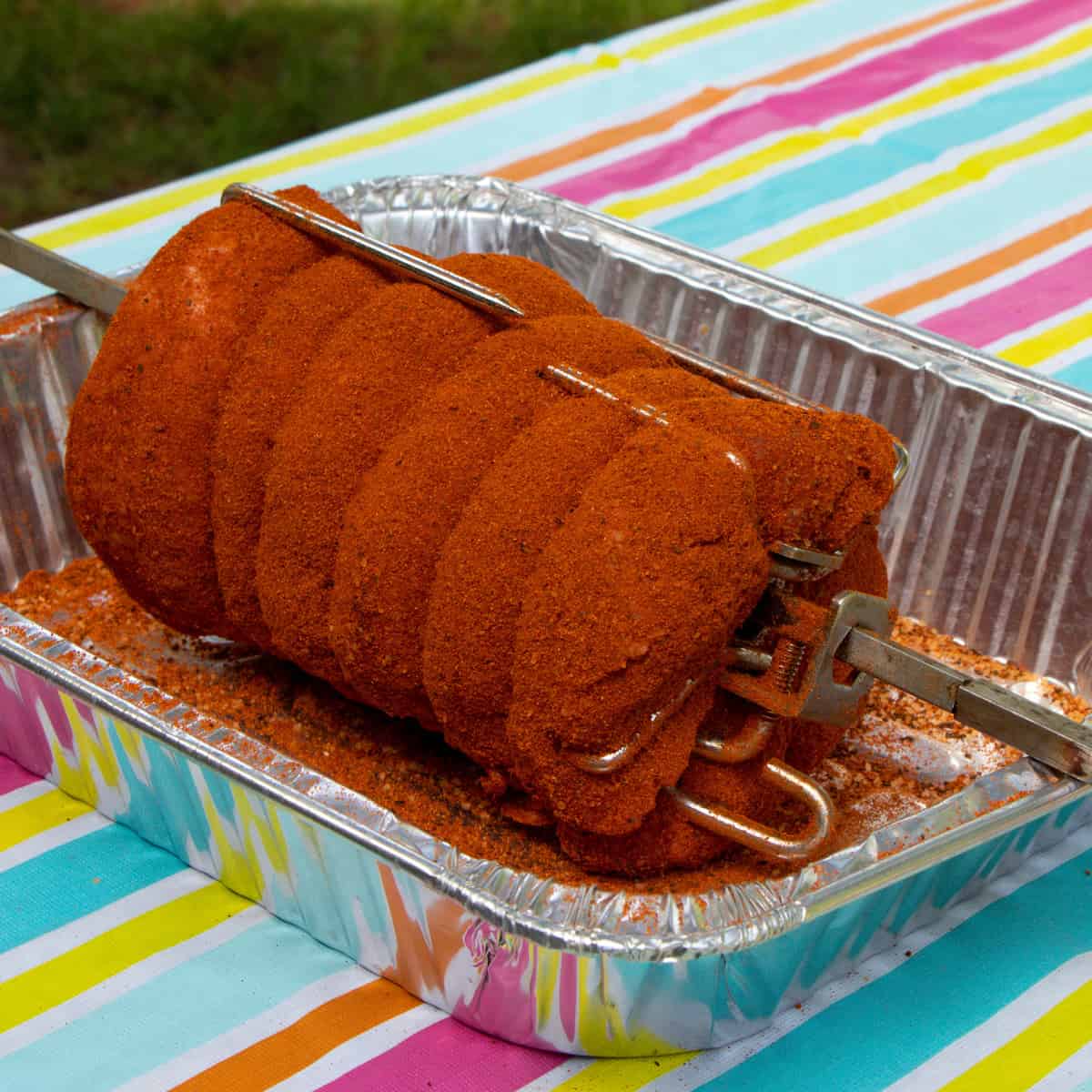 Generously seasoned pork roast ready to go on the grill.