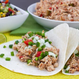 Shredded chicken on soft flour tortilla wraps.