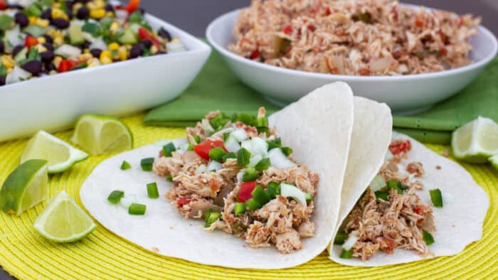 Shredded chicken on soft flour tortilla wraps.