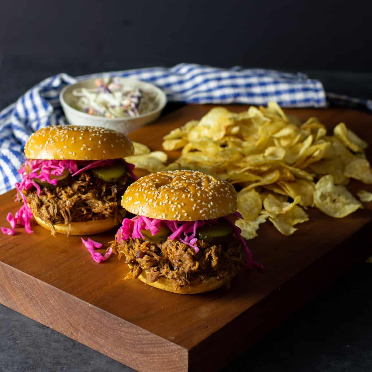 Pulled pork on a brioche bun with potato chips.