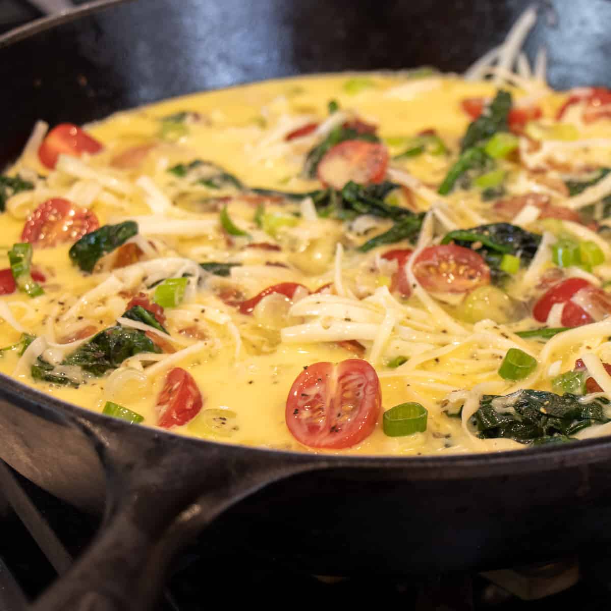 Eggs and milk poured into the pan.