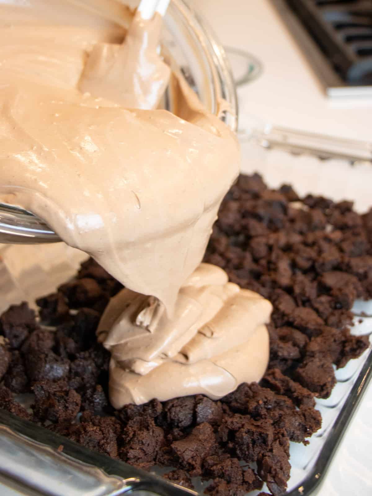 Pouring the chocolate mousse into a baking dish.