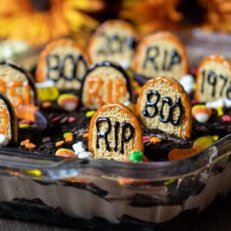 A dessert made with chocolate pudding, brownies and halloween candy.