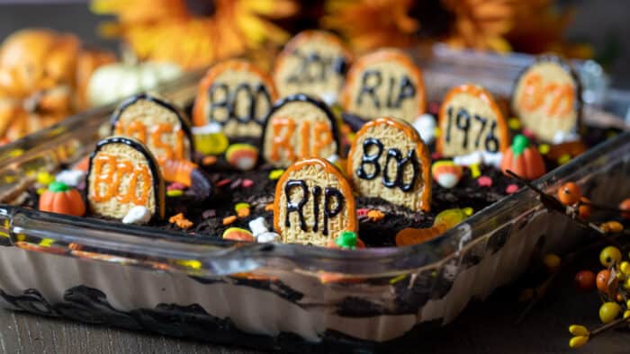 A dessert made with chocolate pudding, brownies and halloween candy.