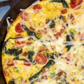 Baked frittata with bacon, spinach and grape tomatoes.