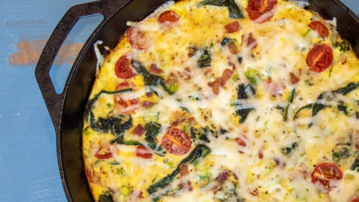 Baked frittata with bacon, spinach and grape tomatoes.