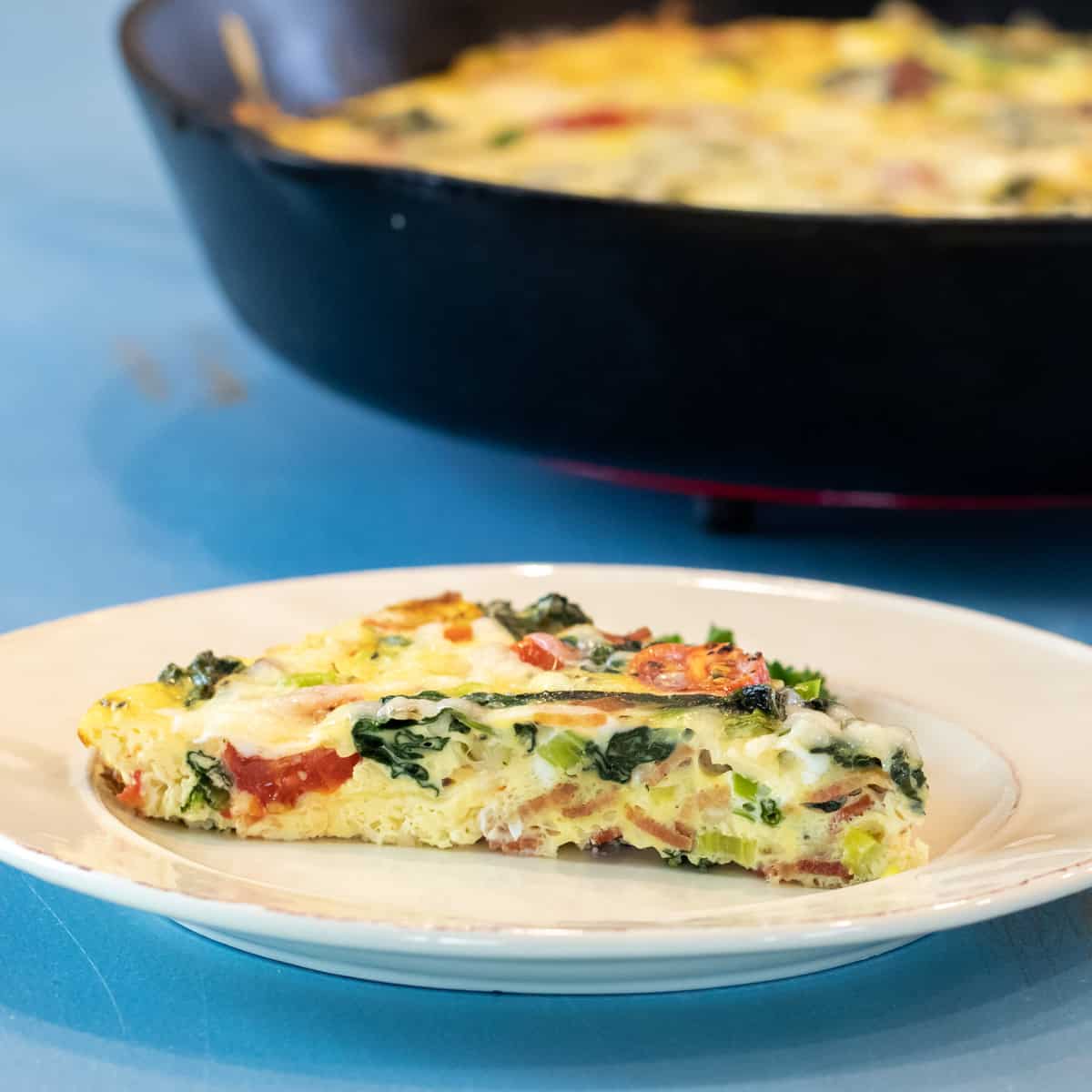 A slice of a frittata on a plate.