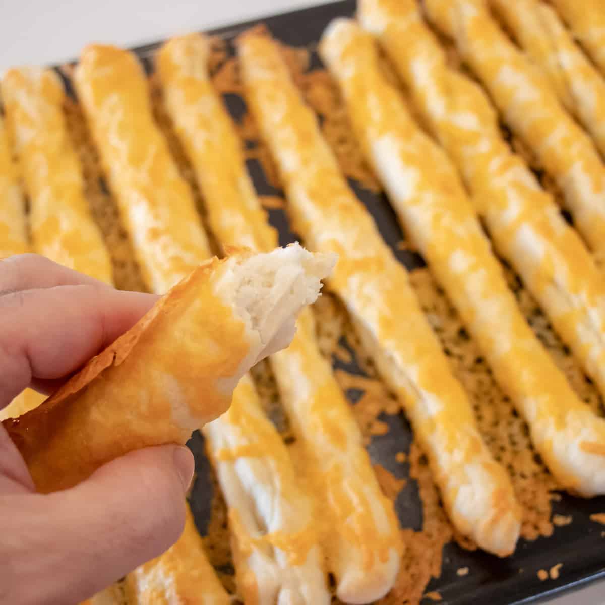 Fresh baked breadstick torn to show the fluffy inside.