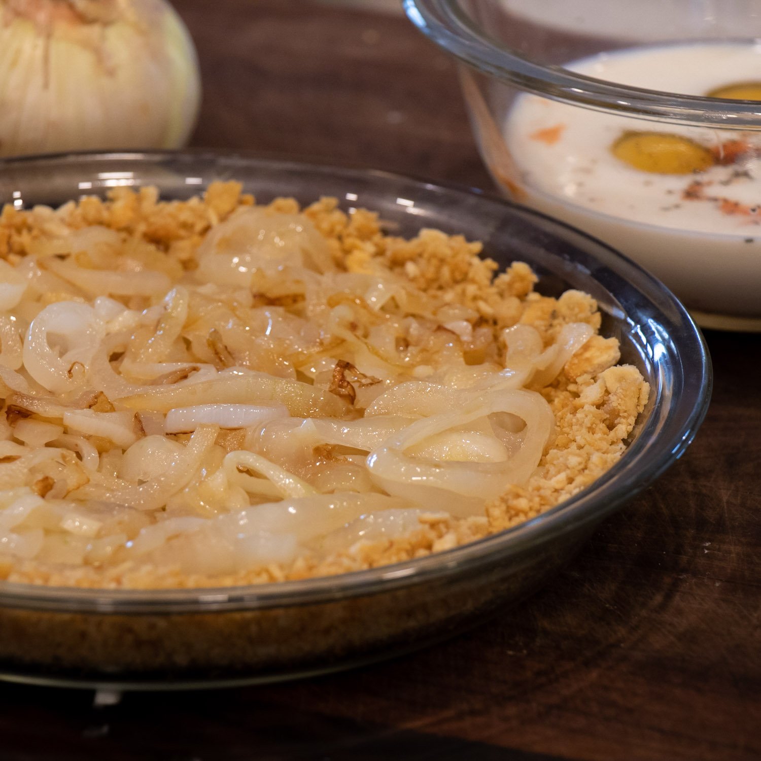 Sautéed onions spread across a pie crust.