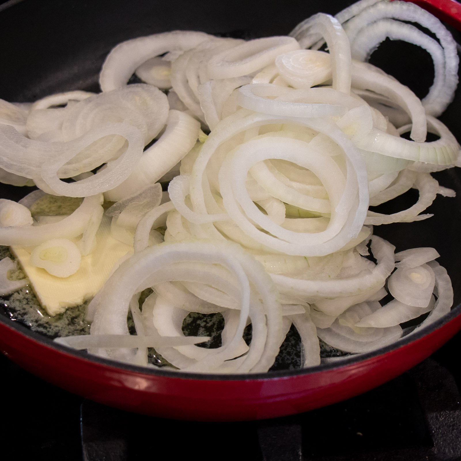 A frying pan of sliced onions.