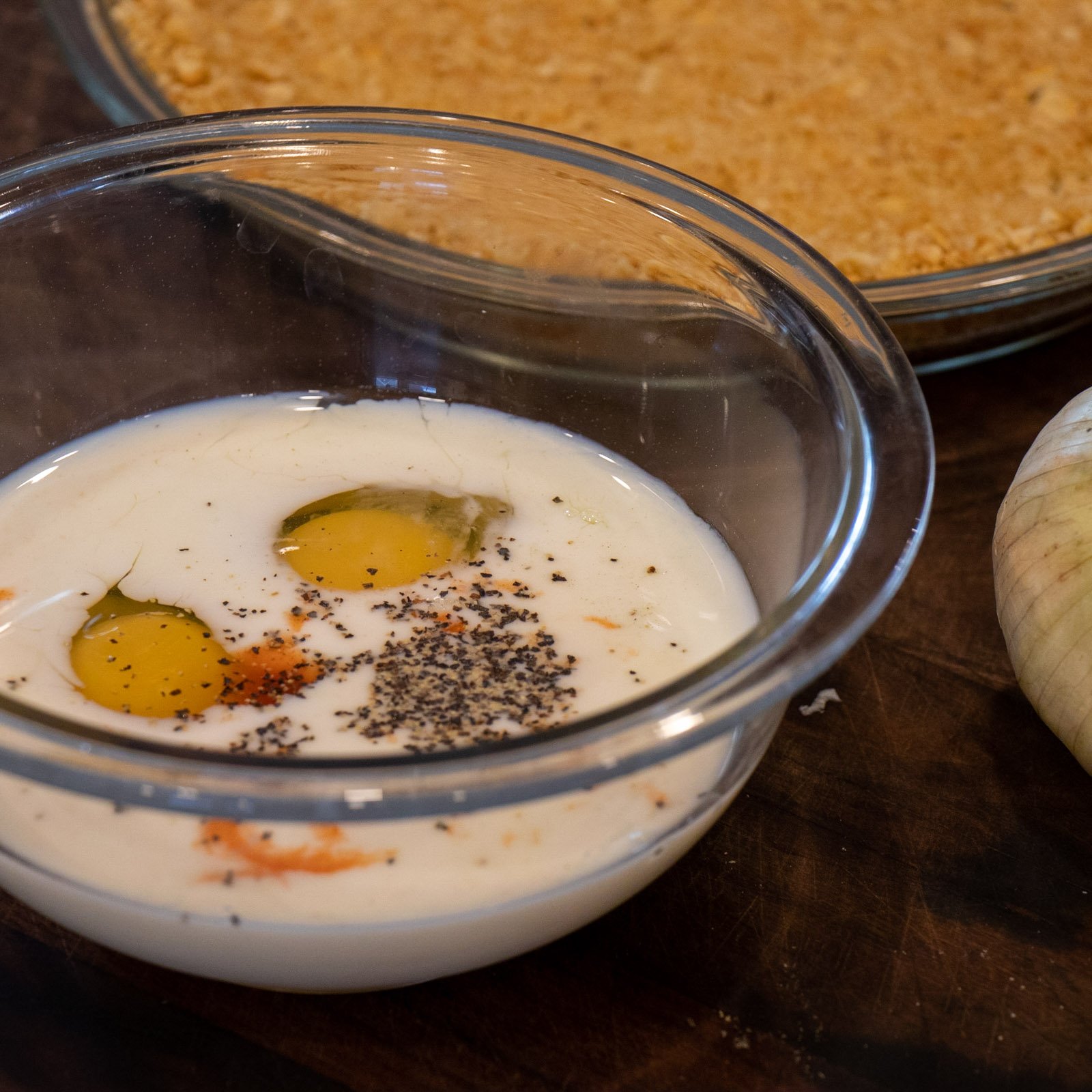 Milk, eggs and spices in a bowl.