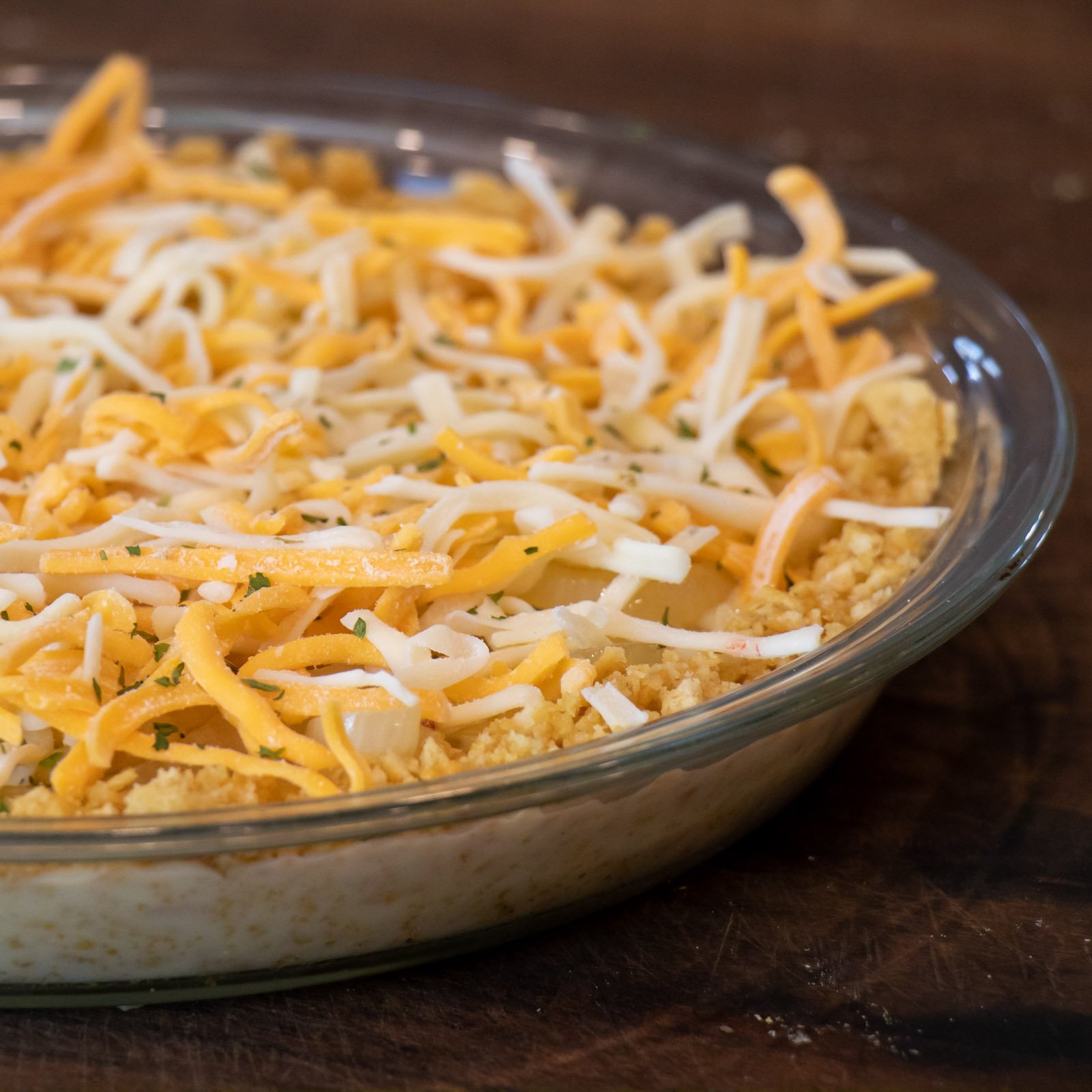 Grated cheese and dry parsley sprinkled on top of the pie.