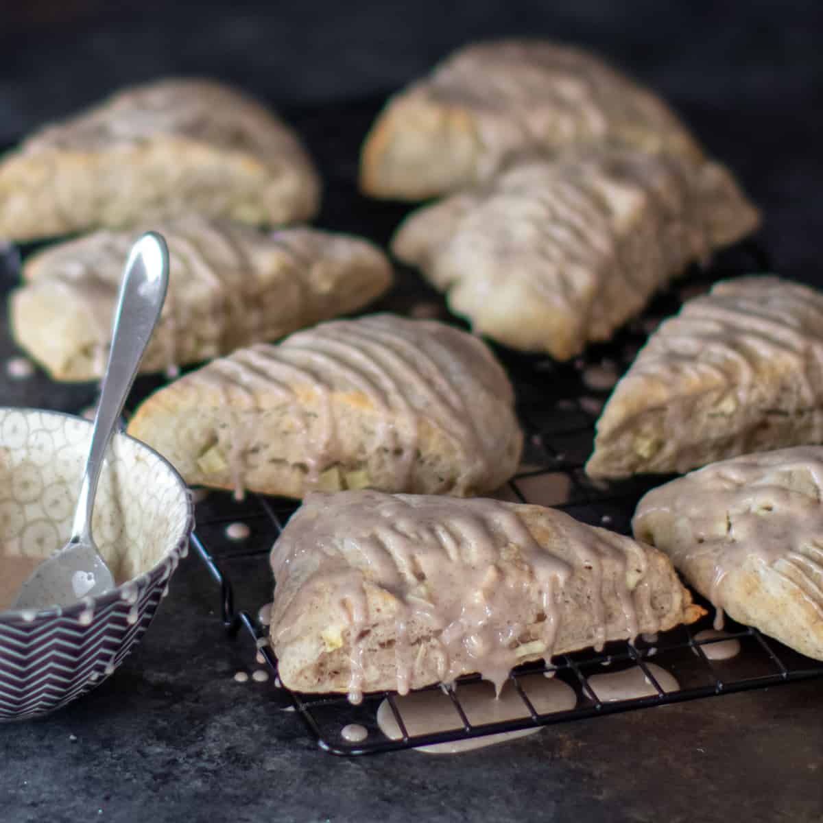 A rack with 8 scones drizzled with glaze.