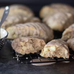 Fresh baked scones on a cooling rack with one broken in half.