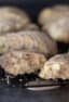 Fresh baked scones on a cooling rack with one broken in half.