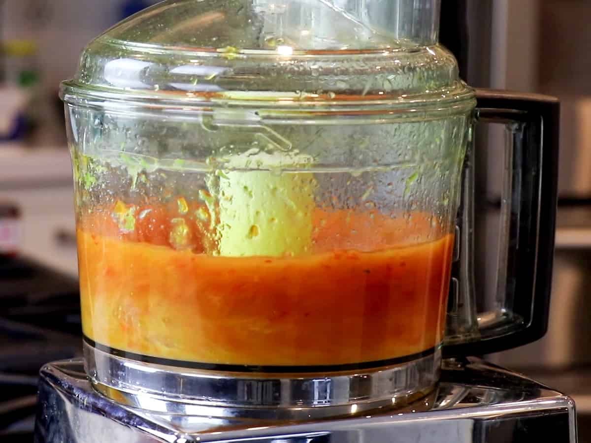 A food processor turned on and blending wing marinade.