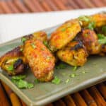 Baked chicken wings on a plate.