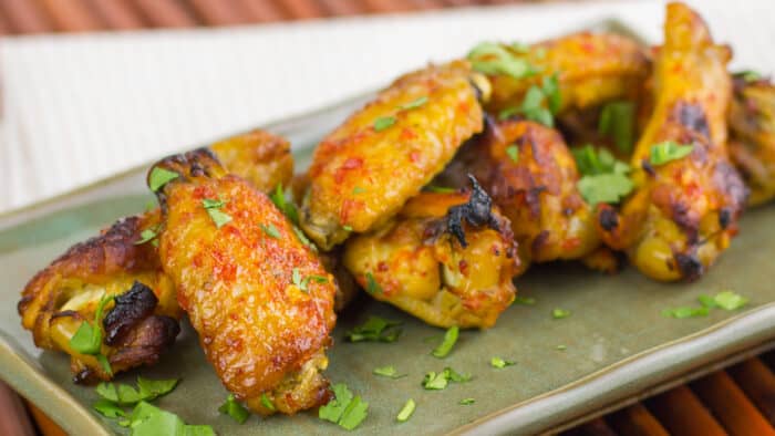 A plate of baked chicken wings.