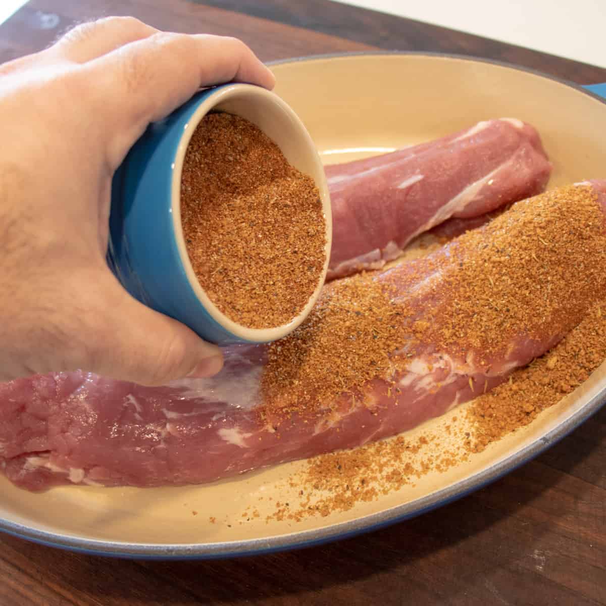 BBQ seasoning blend being sprinkled on the meat.