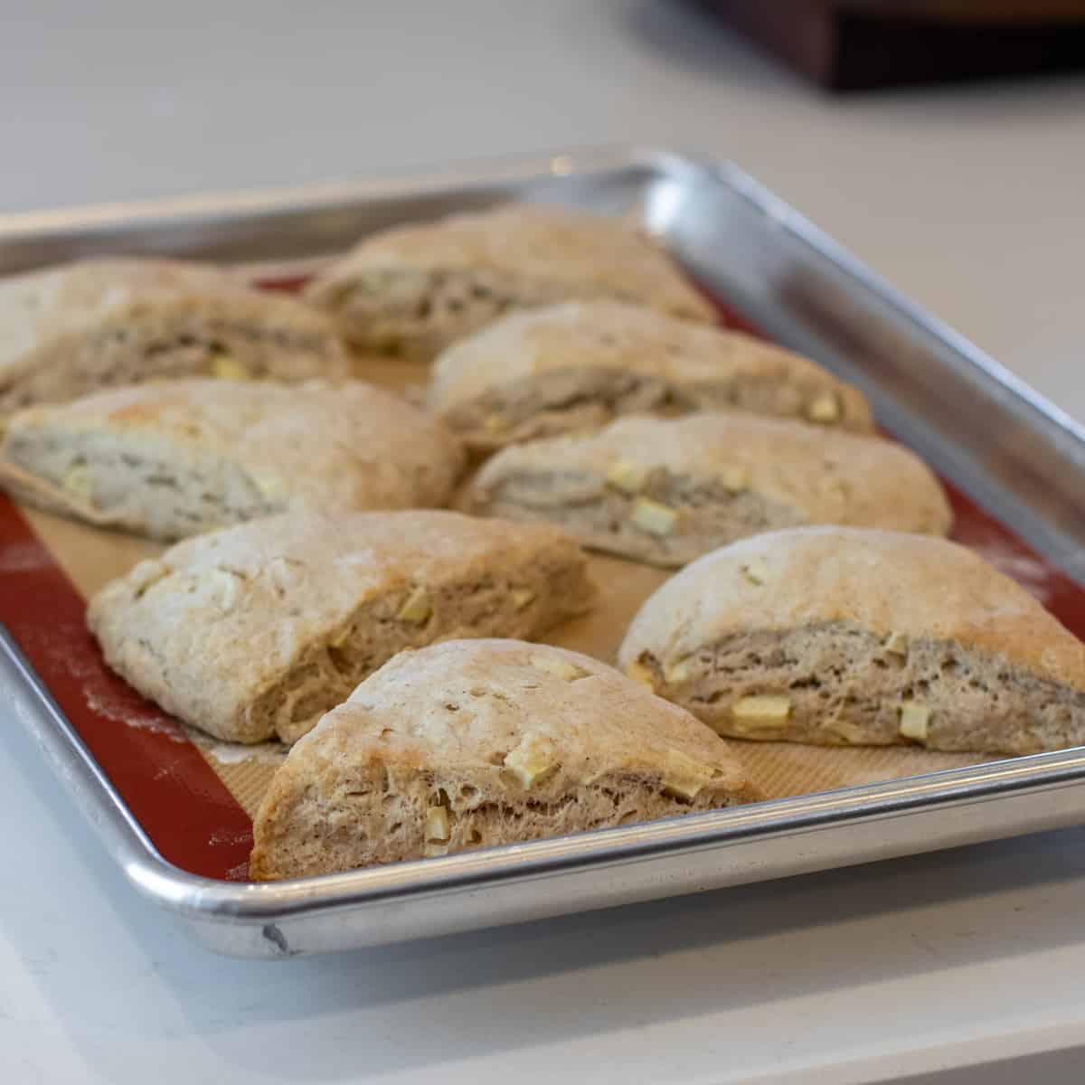 Fresh baked scones on a baking sheet.
