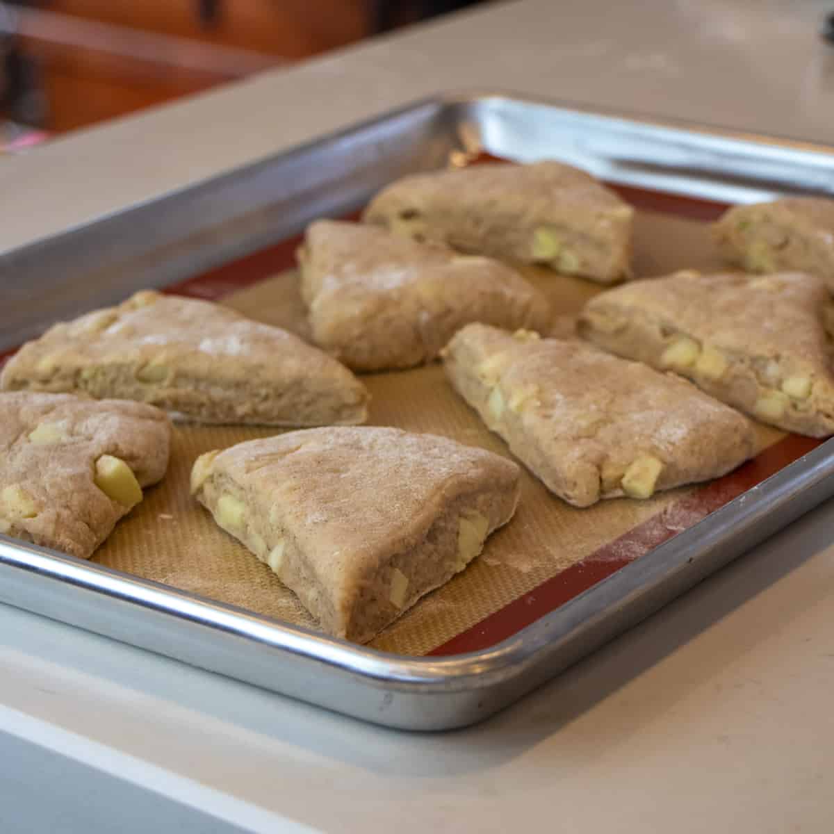 Unbaked scones on a baking sheet.