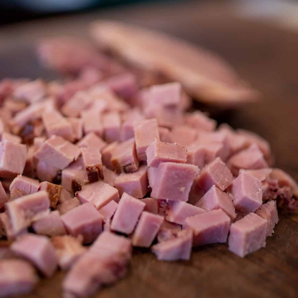 Diced ham on a cutting board.