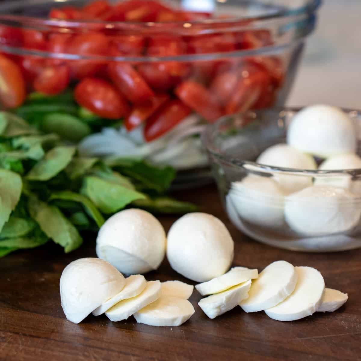 Fresh bocconcini cheese sliced into thin medallions.