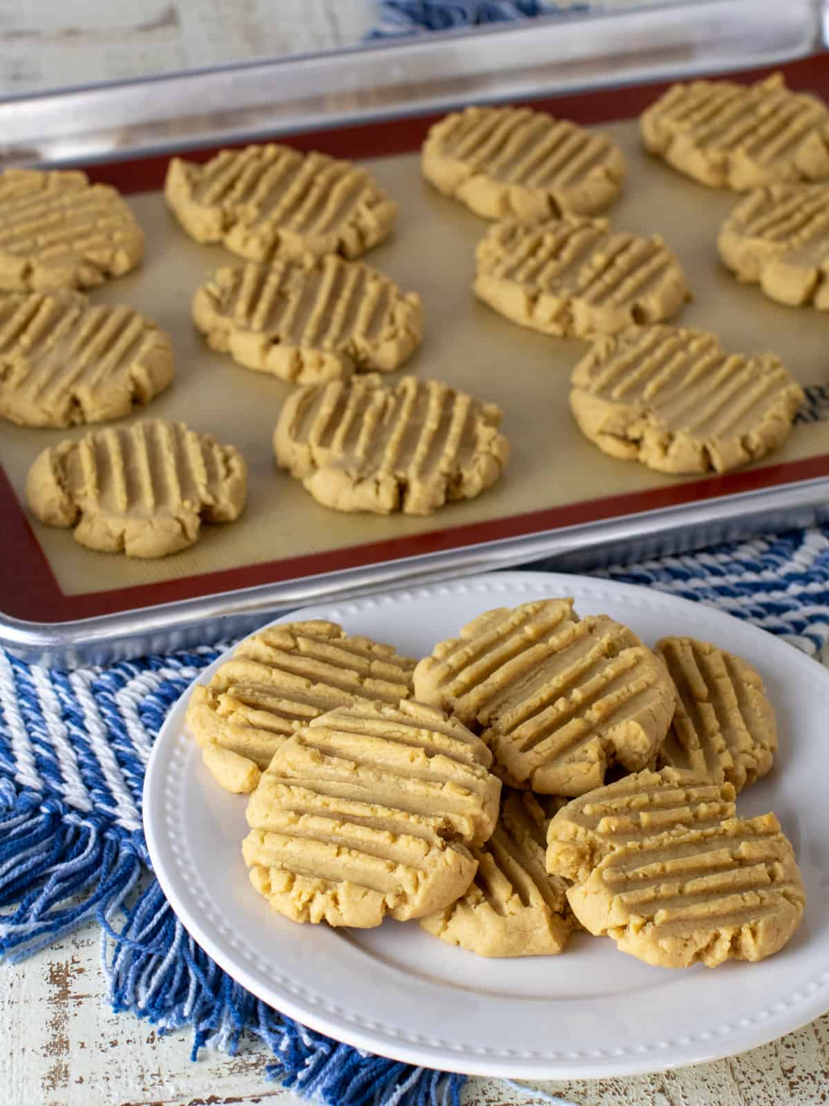 Cookies on a baking sheet and a plate.