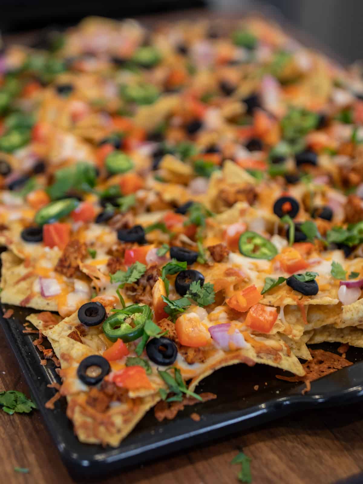 A baking stone of nachos.