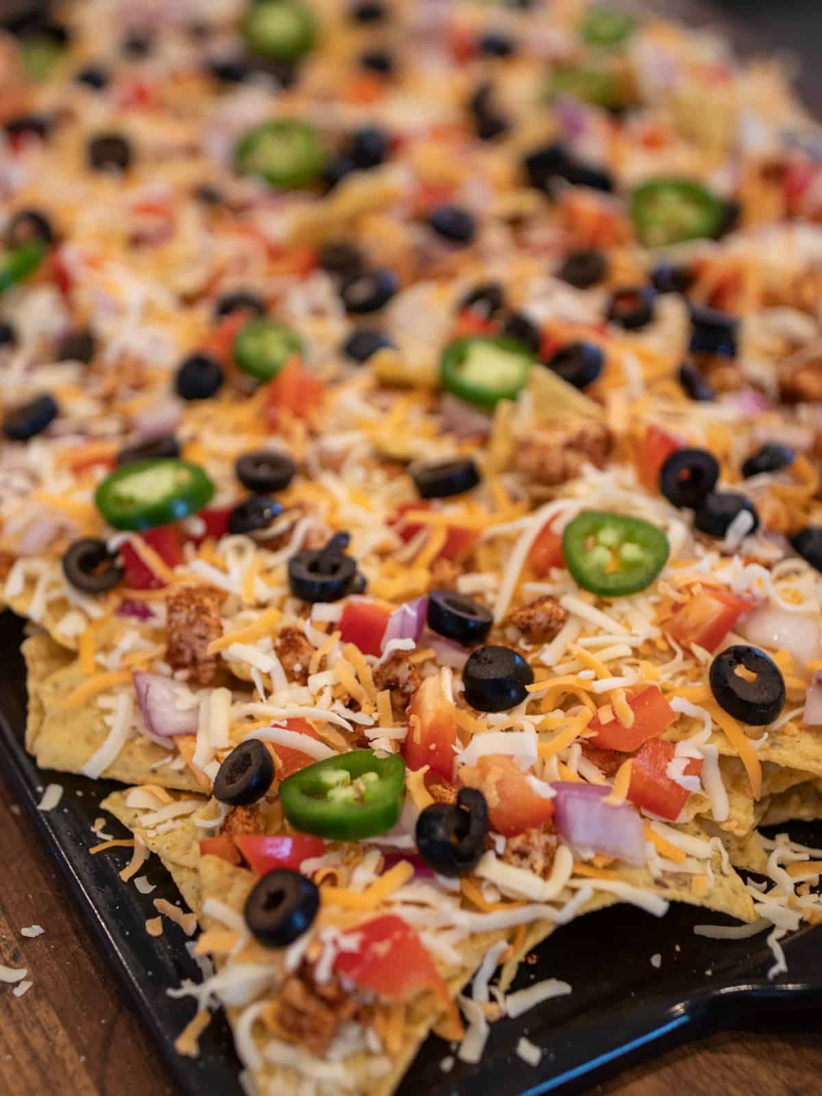 A tray of nachos ready to go into the oven.