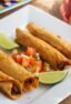 A plate of flautas ready to serve.