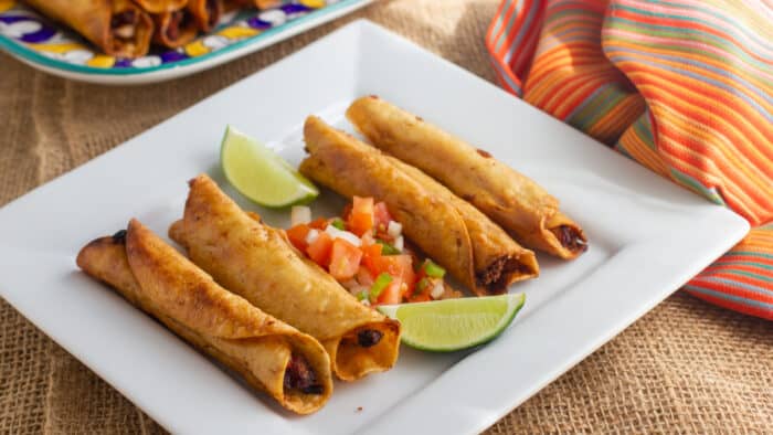 A plate of flautas ready to serve.