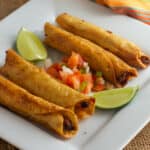 A plate of Mexican chicken flautas