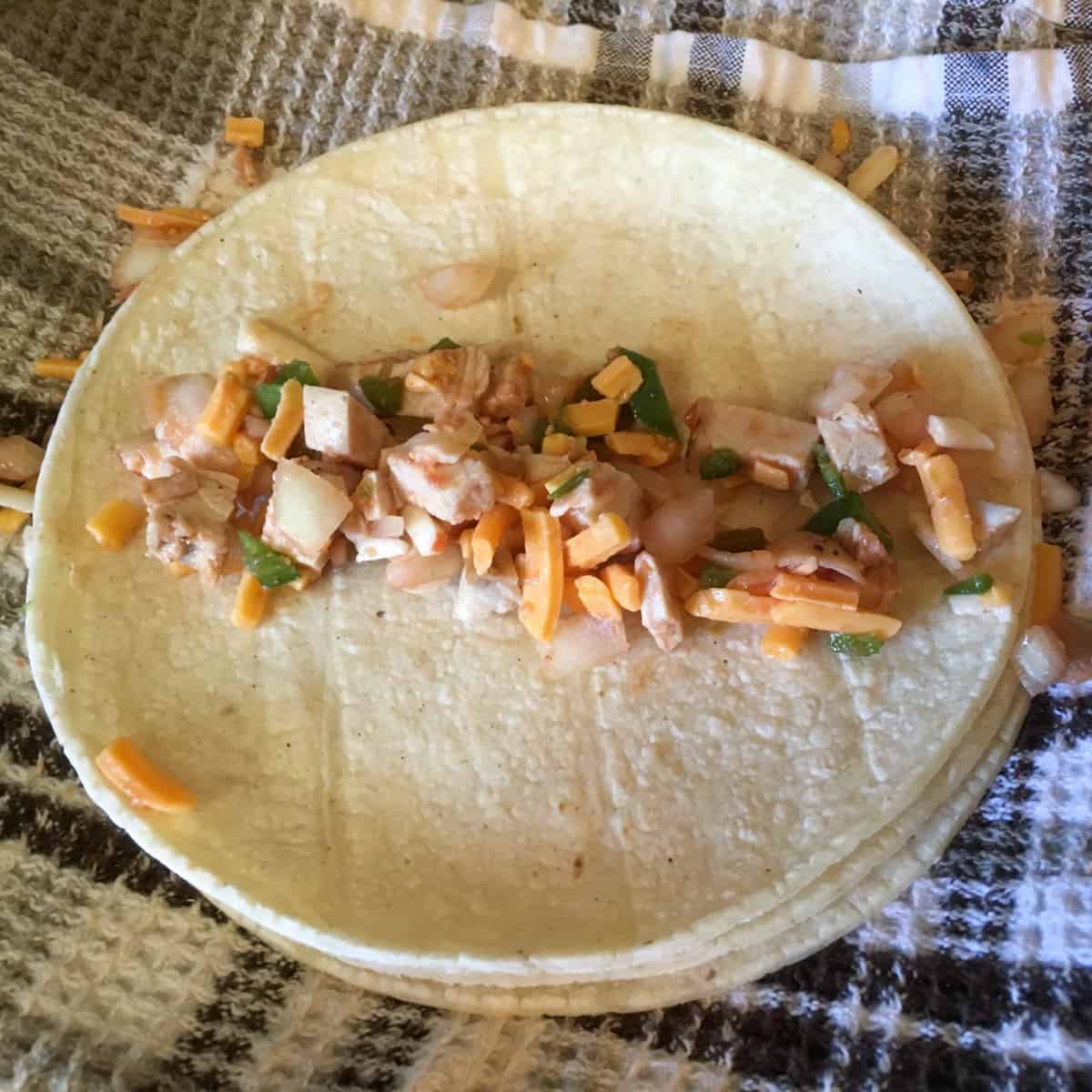 Chicken filling on a soft tortilla.