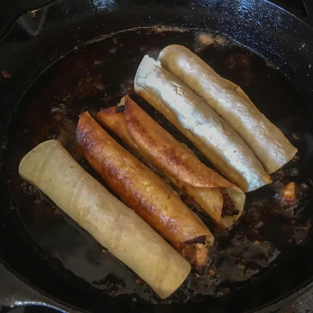 Five flautas in a frying pan.
