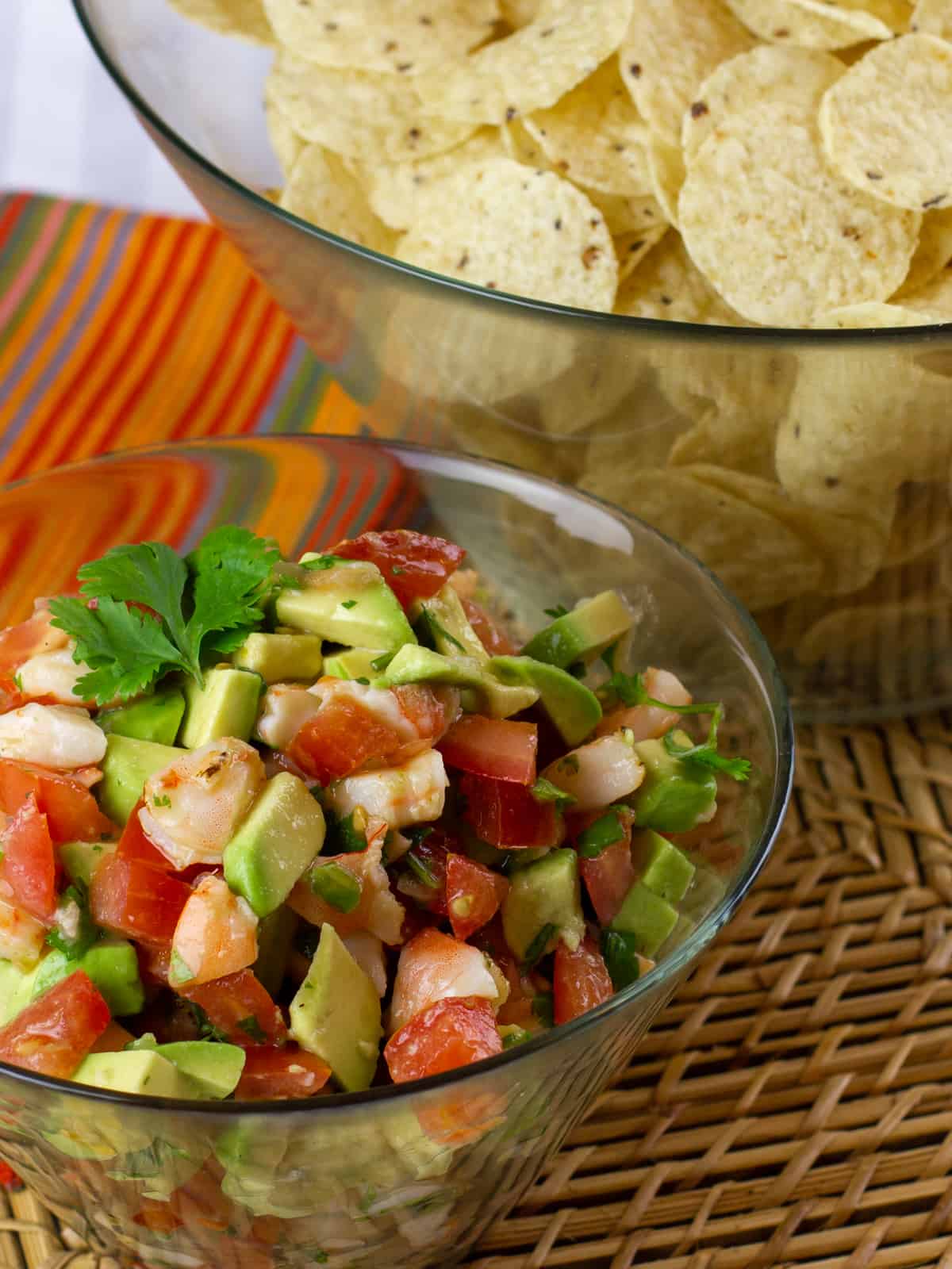 An overhead picture of this seafood salsa in a bowl with some round tortilla chips in another bowl behind.